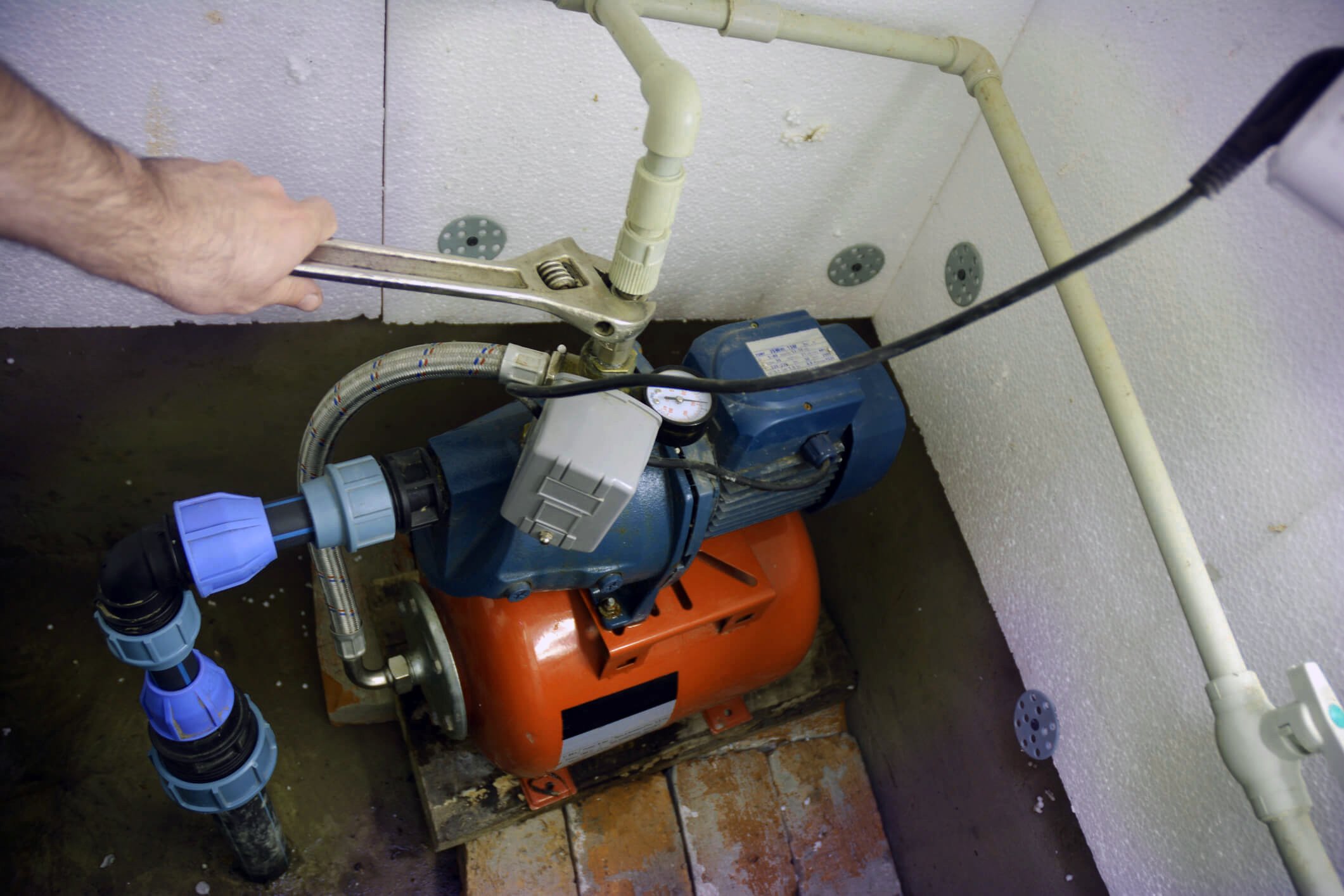 Contractor installing and repairing water pumping station